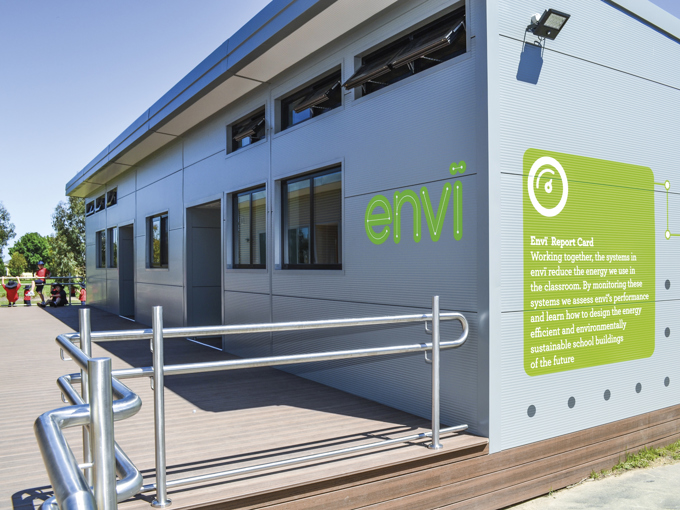 Modern modular school building with small open windows on exterior wall, featuring handicap-accessible ramp.